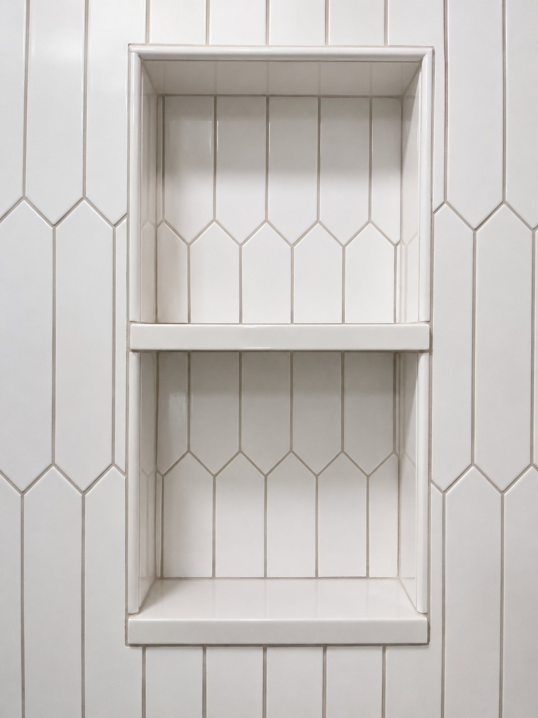 White picket tile work with built-in niche shelves